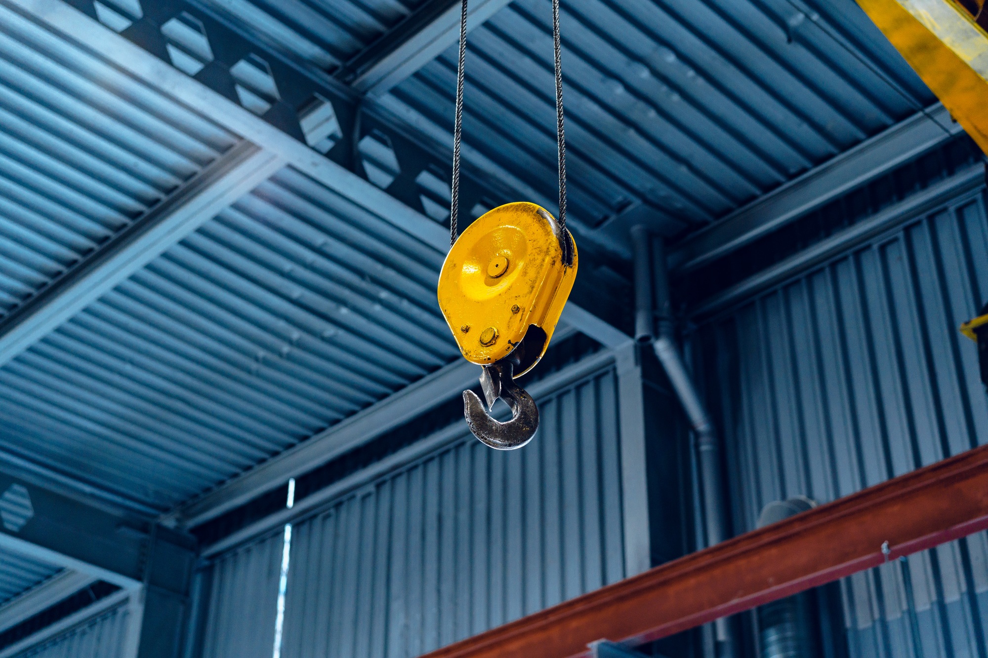 Industrial crane hook in a modern factory building
